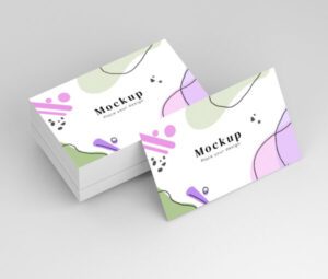 Stack of smooth silk standard business cards with modern abstract design in pastel colours, printed double-sided