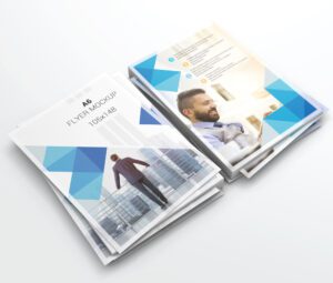 Two stacks of A6 flyers with a modern blue geometric design, showcasing business themes, a man smiling, and a person walking in a city.