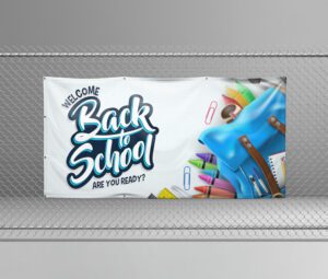 A 'Welcome Back to School' PVC banner with colorful school supplies, perfect for marketing and events.