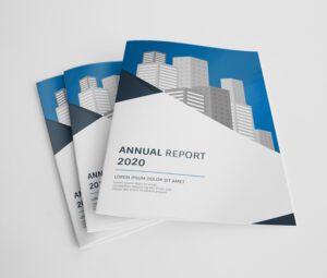 Stack of professional A4 laminated cover booklets featuring an 'Annual Report' design with a city skyline graphic.