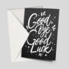A modern A6 4pp greeting card with a stylish “Good Bye & Good Luck” message in white font on a black background. This stock photo shows the card and its white envelope, perfect for farewells.