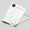 Photo of personalized Millie Brown Graphic Design letterheads with a green design and contact information at the bottom.