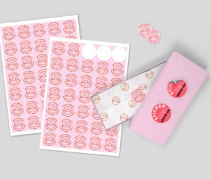 Customizable pink circle stickers with a donut logo, showcasing different size sheets and a product box mock-up for branding.